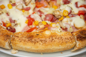 peasant pizza with cabanas, ham, sesame and olives