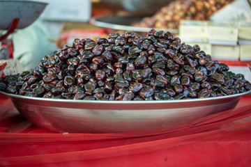 A fresh organic date displayed in metal tray in the market