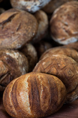 large assortment of freshly baked bread at local bakery, stacked loaves, artisan loaf of bread