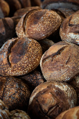 large assortment of freshly baked bread at local bakery, stacked loaves, artisan loaf of bread