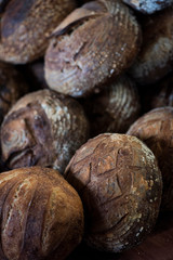 large assortment of freshly baked bread at local bakery, stacked loaves, artisan loaf of bread
