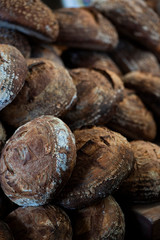 large assortment of freshly baked bread at local bakery, stacked loaves, artisan loaf of bread