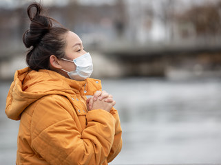 The image of a young Asian woman wearing a mask to prevent germs, toxic fumes, and dust. Prevention...