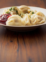 Portion of traditional large dumplings with meat on a white plate