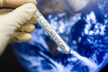 Obraz premium coronavirus epidemic in the world. Test tube on the background of the planet.