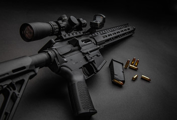 Modern automatic carbine with optical and collimator sight. A rifle with two sights on a dark...
