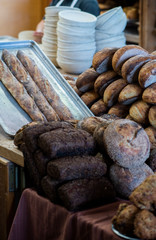 large assortment of freshly baked bread at local bakery, stacked loaves, artisan loaf of bread