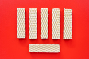 Wafer cookies on red background. Top view.