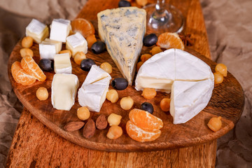 Assorted cheeses on a wooden Board. 