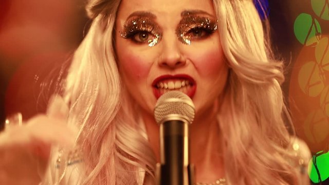Video clip young woman singer in a New Year costume Snow Maiden sings a song in stage light
