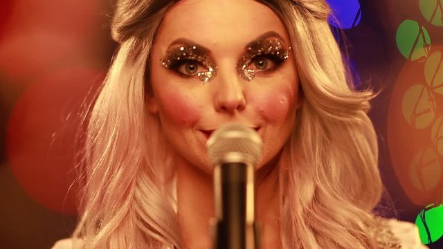 Video clip young woman singer in a New Year costume Snow Maiden sings a song in stage light