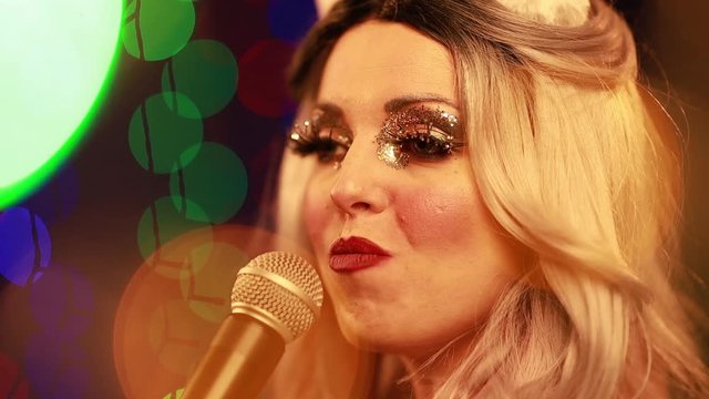 Video clip young woman singer in a New Year costume Snow Maiden sings a song in stage light