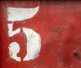 Number 5 (five) on an old rusty metal background. Texture of old paint and rust on the numbers