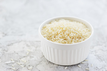 White rice in a bowl on a gray table. Gluten free, healthy diet concept. Horizontal orientation, copy space.