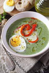 Green pea soup with spinach. Olive oil, red grilled bell pepper and half boiled egg dressing