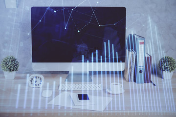 Forex graph hologram on table with computer background. Double exposure. Concept of financial markets.