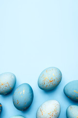 Easter frame of eggs painted in blue color. Flat lay, top view. Copy space for text.