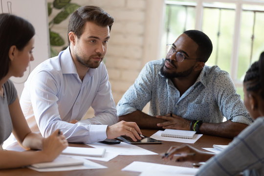 Busy Diverse Employees Listening European Coach At Group Meeting