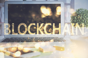 Multi exposure of blockchain and crypto economy theme hologram and table with computer background. Concept of bitcoin cryptocurrency.