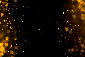 Golden abstract bokeh on black background. Holiday concept