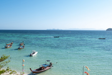 long-tailed boat in Blue sea and sky with white clouds at beauty day light