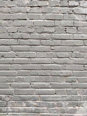 Painted brick wall of an architectural structure in light gray color. Fashionable texture for design.