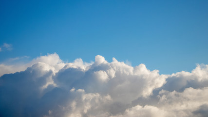 Fototapeta na wymiar Volumetric white curly clouds in the blue sky_