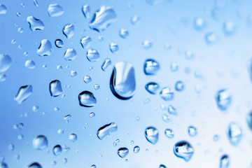 Raindrops close up on window glass, rainy weather, background for design_