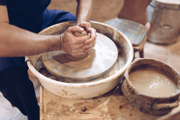 Potter making a clay vase on a potter's wheel