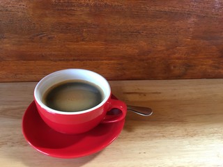 cup of coffee on wooden table