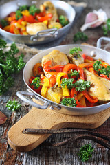 Stewed chicken with bell peppers, parsley and garlic