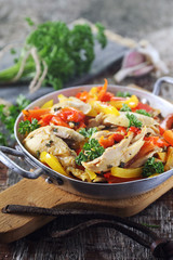 Stewed chicken with bell peppers, parsley and garlic