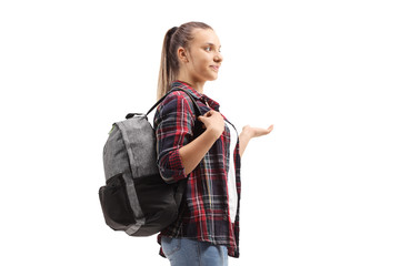 Teenage female student standing and gesturing with her hand