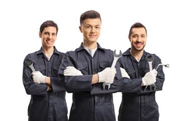 Group of male workers in uniforms with tools