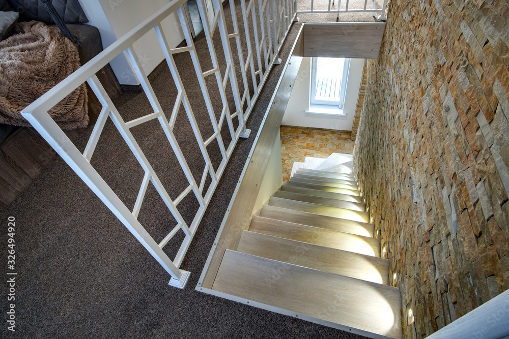 Wall mural Interior of a contemporary home with spacious hallway, room doors and staircase railing in modern style.