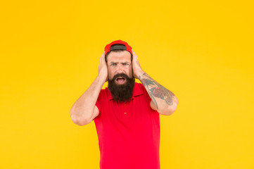 Oh no. Hiring shop worker. Hipster cashier. Delivery service. Restaurant cafe staff wanted. Man bearded tattooed cap cashier uniform yellow background. Cashier concept. Salesman cashier career