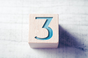 Number 3 On A Wooden Block On A Table