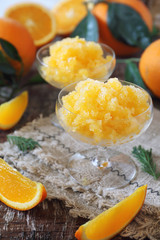 Orange granita, frozen summer dessert and  freshe orange fruits