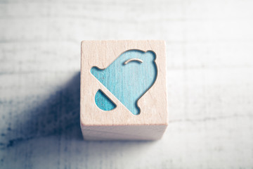 Subscribe Alarm Bell Icon On A Wooden Block On A Table