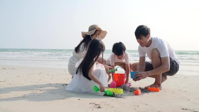 4k slow-motion Asian Family playing together at beach with kids happy vacation travel beach concept