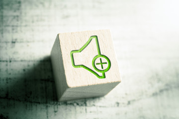 Volume Up Icon On A Wooden Block On A Table