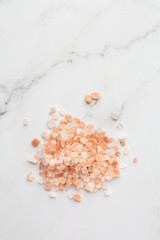 Fototapeta na wymiar Pink salt isolated on white background.Close up one portion, heap of crystals red Hawaiian salt isolated on white background, elevated top view, directly above. . Cooking, spices and kitchen concept.