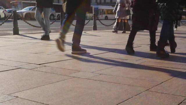 Feet of people walking on a city street