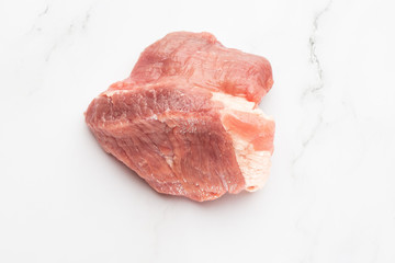 Meat, pork, slices pork loin on a white background. Raw pork meat. Advertising for meat shop and farm. Various kinds of meat and ready to cook concept. Top view. Space for text