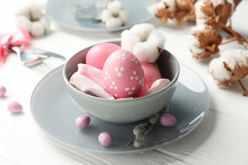 Easter table setting on white wood background, close up