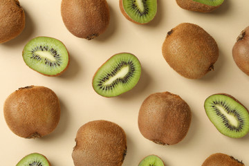 Fototapeta premium Ripe sweet kiwi on beige background, top view
