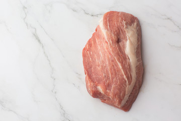 Meat, pork, slices pork loin on a white background. Raw pork meat. Advertising for meat shop and farm. Various kinds of meat and ready to cook concept. Top view. Space for text