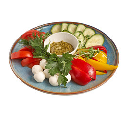 assorted vegetables with mozzarella balls on blue plate, on white background. photo for the menu.