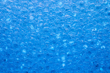 Blue abstract background with texture of small soap bubbles close up - banner background