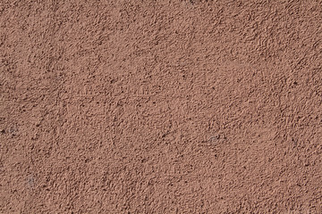 Background image - the wall of the building plastered with textured stucco pale pink